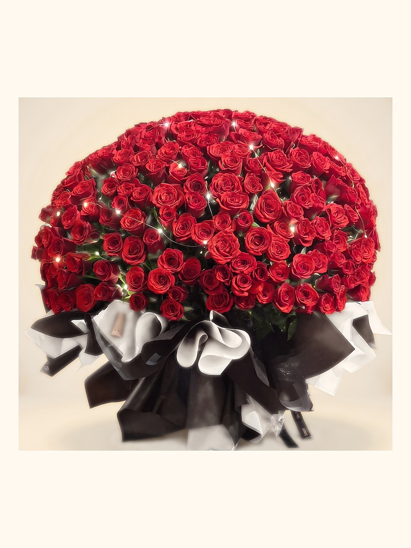 A tall dome of deep red roses in a black wrap