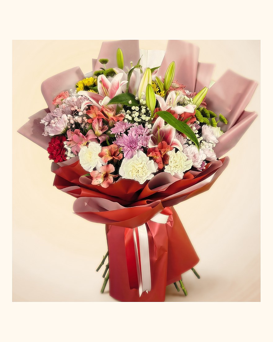Coral alstroemeria, pink lilies and lilac chrysanthemums in a grey wrap