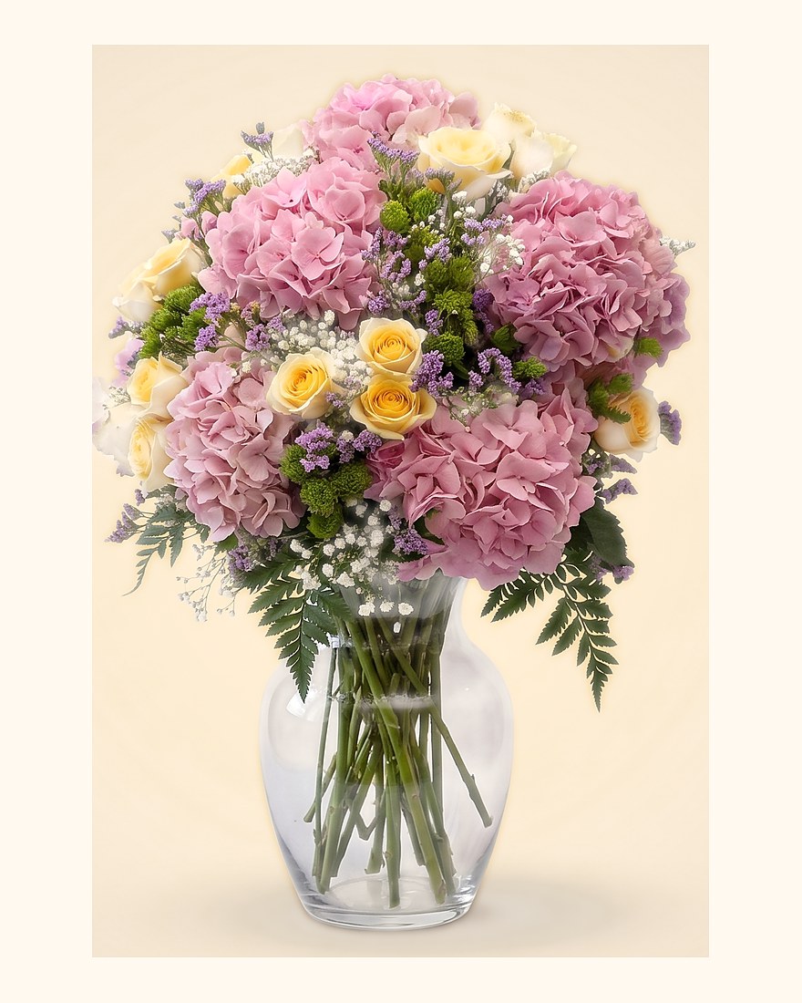 Pink hydrangeas and carnations in a clear glass vase