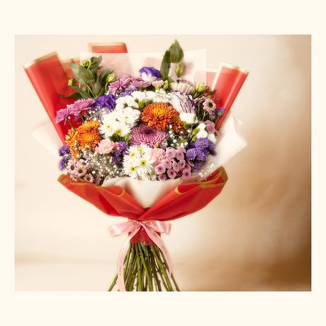 Orange, purple and lilac blooms in a coral wrap