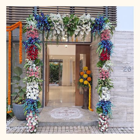 An entrance archway dressed with flowers and marigolds