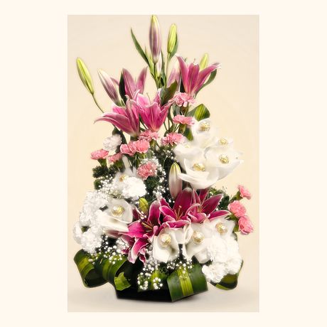 Pink lilies and white lisianthus in a pale wrap