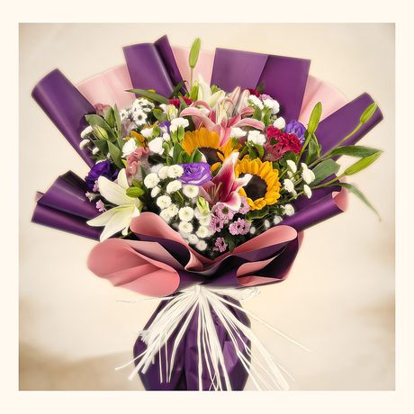 Sunflowers and mixed blooms in a purple wrap