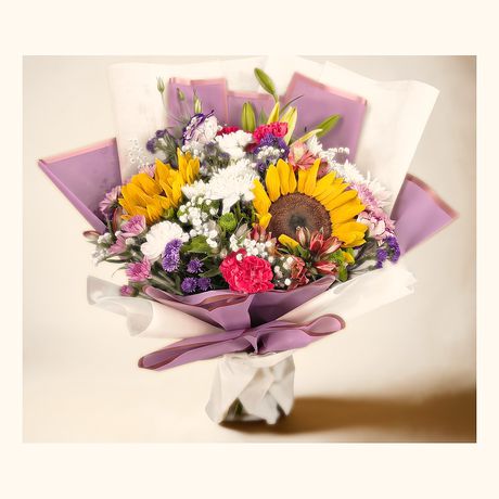 Sunflowers with lilac and pink carnations in a grey wrap