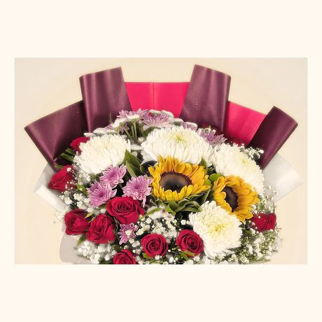 Sunflowers, white chrysanthemums and red roses in a maroon wrap