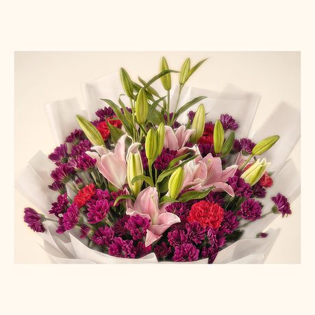Pink lilies with magenta carnations in a grey wrap