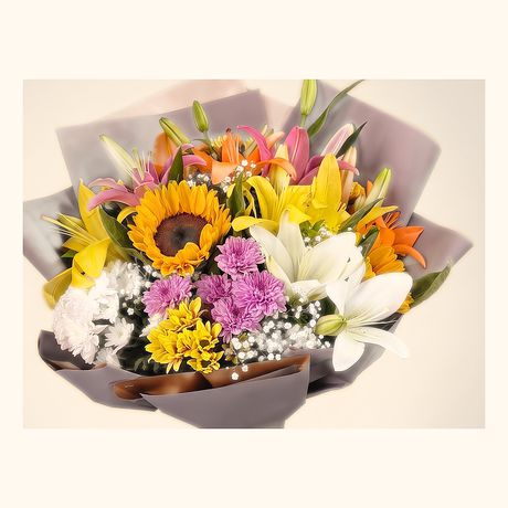 Sunflowers, lilies and pastel blooms in a grey wrap