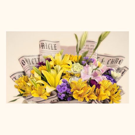 Yellow lilies and lilac blooms in a kraft paper wrap